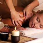 masseur-doing-massage-female-shoulder-beauty-salon-scaled