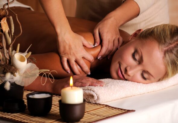 masseur-doing-massage-female-shoulder-beauty-salon-scaled